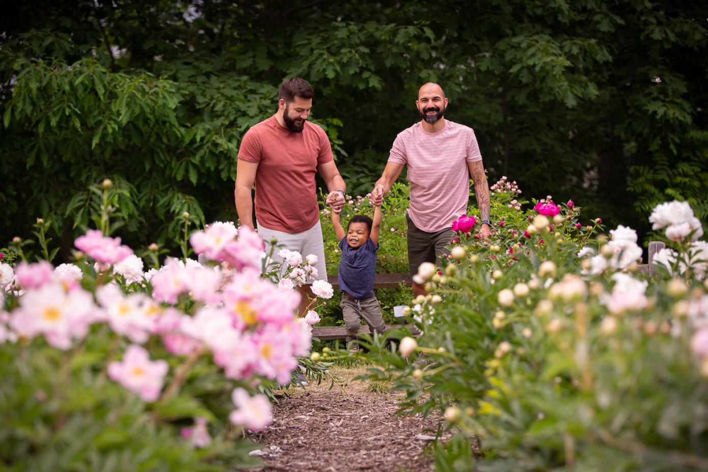Two adults and a child touring the peony garden