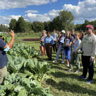 jeremy talks to group of students at the campus farm