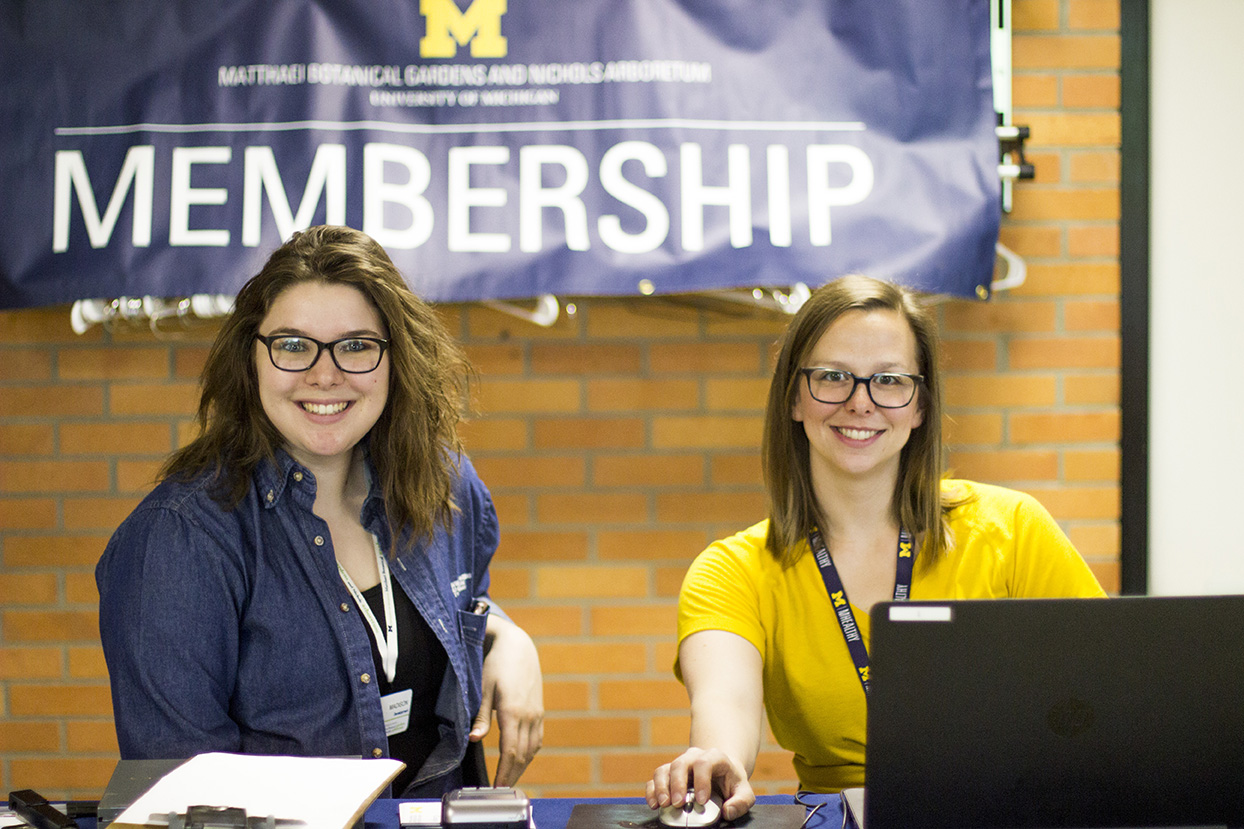 Two people at a membership desk