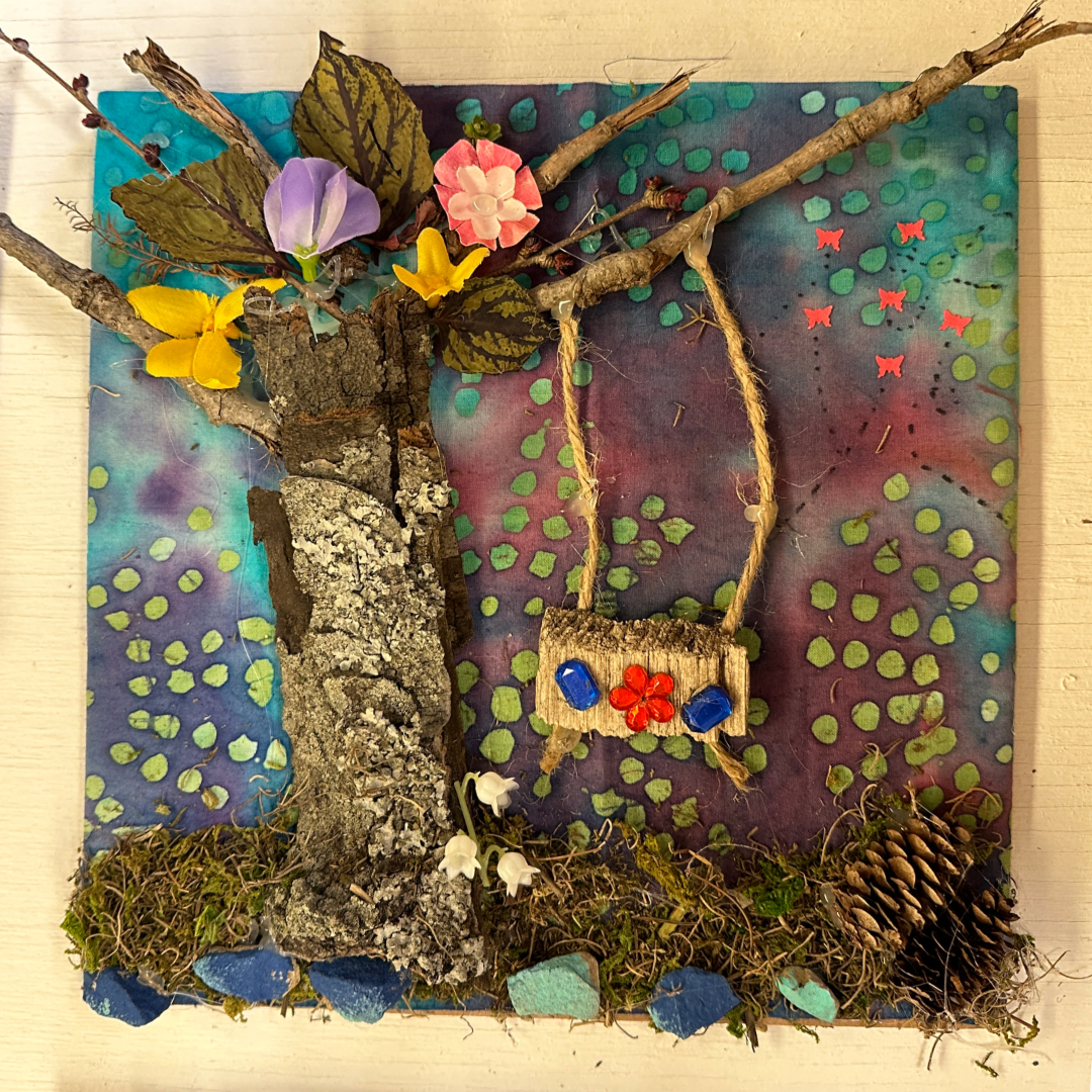 Natural materials art collage with a tree and swing shown