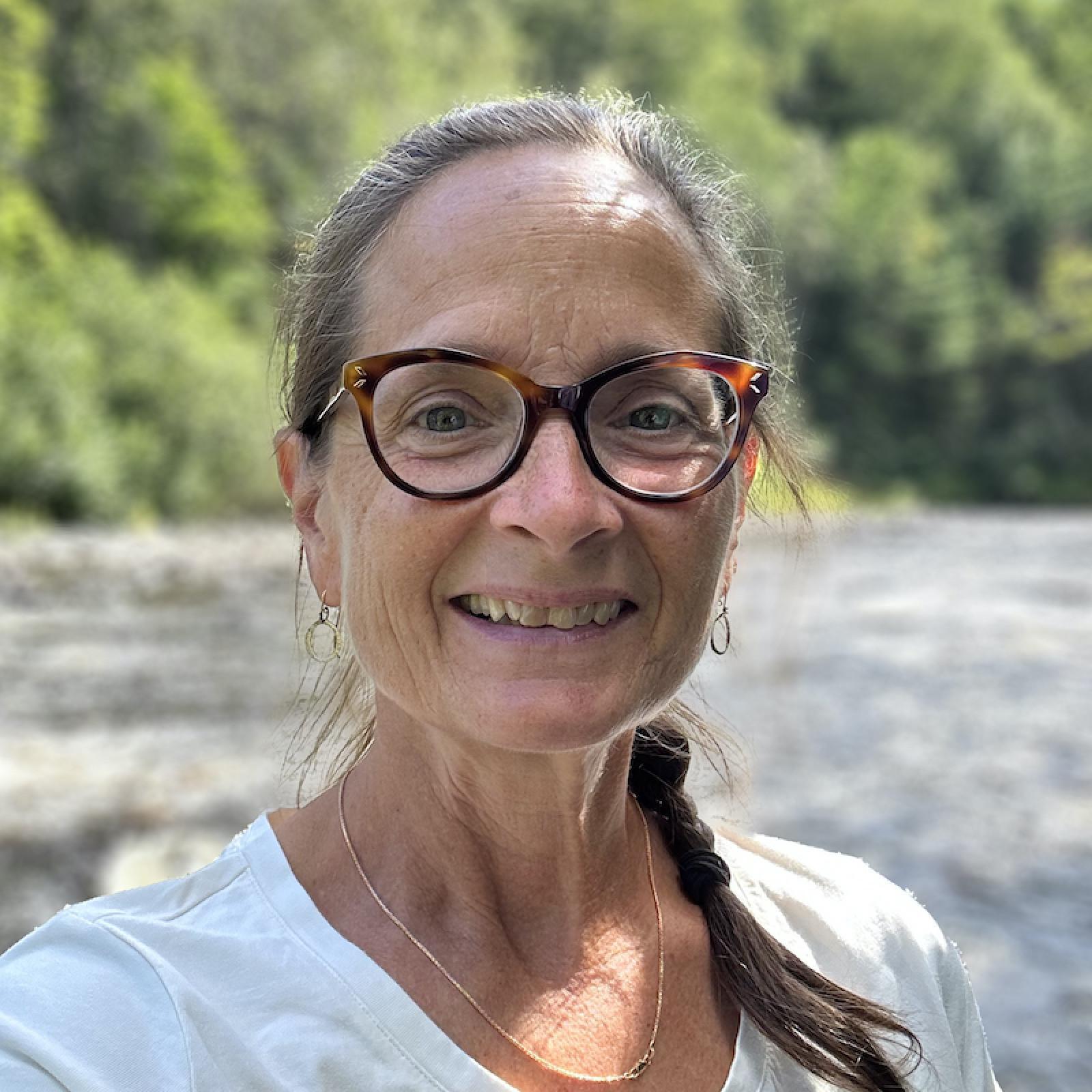 Liz Glynn outside in front of a river