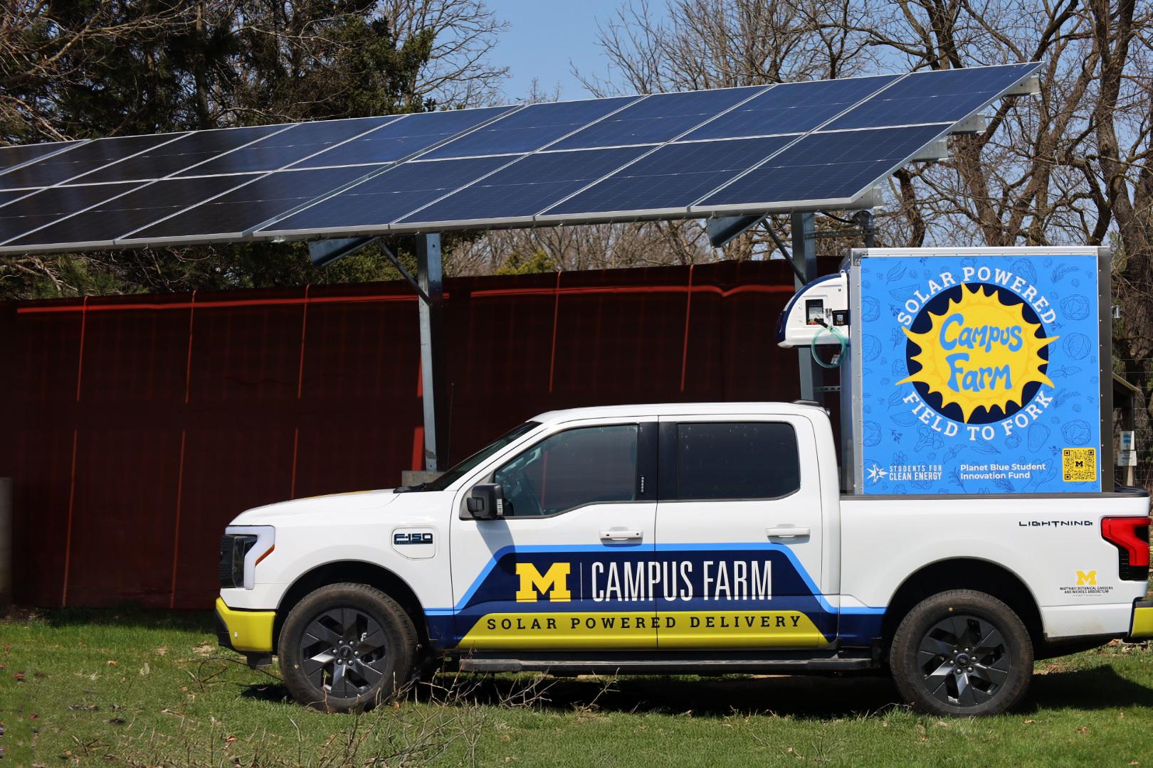 Campus Farm EV truck parked under solar array