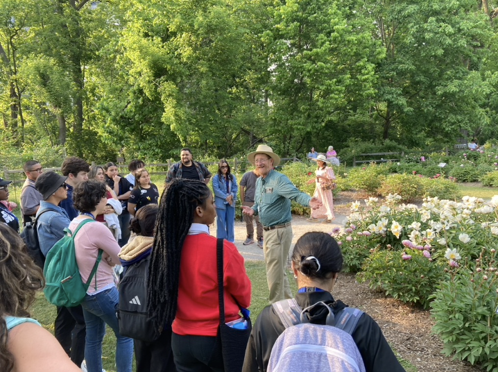 David Michener talking to people in peony garden