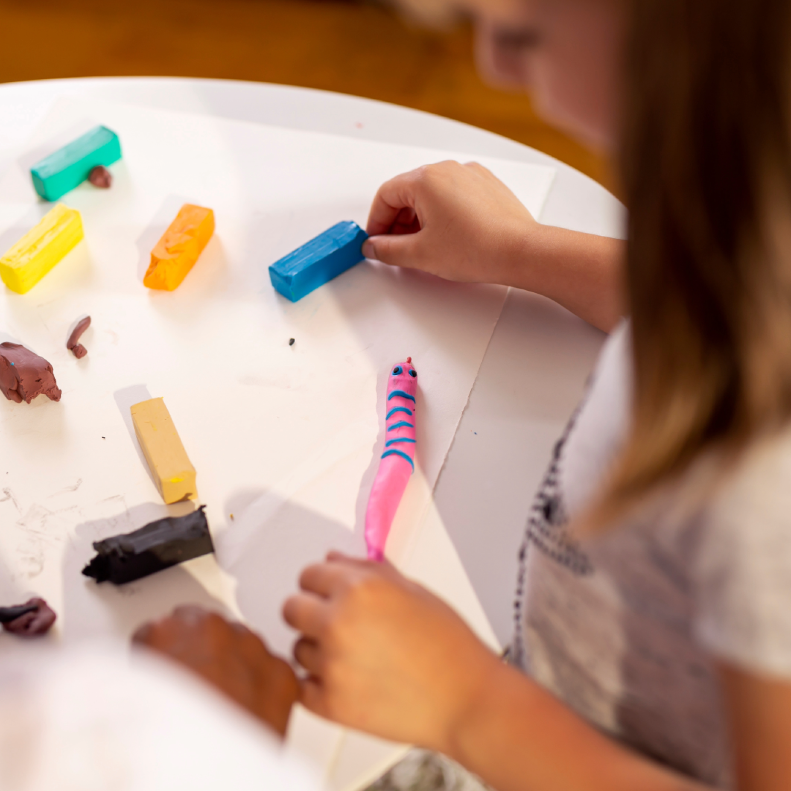 A child playing with craft clay.