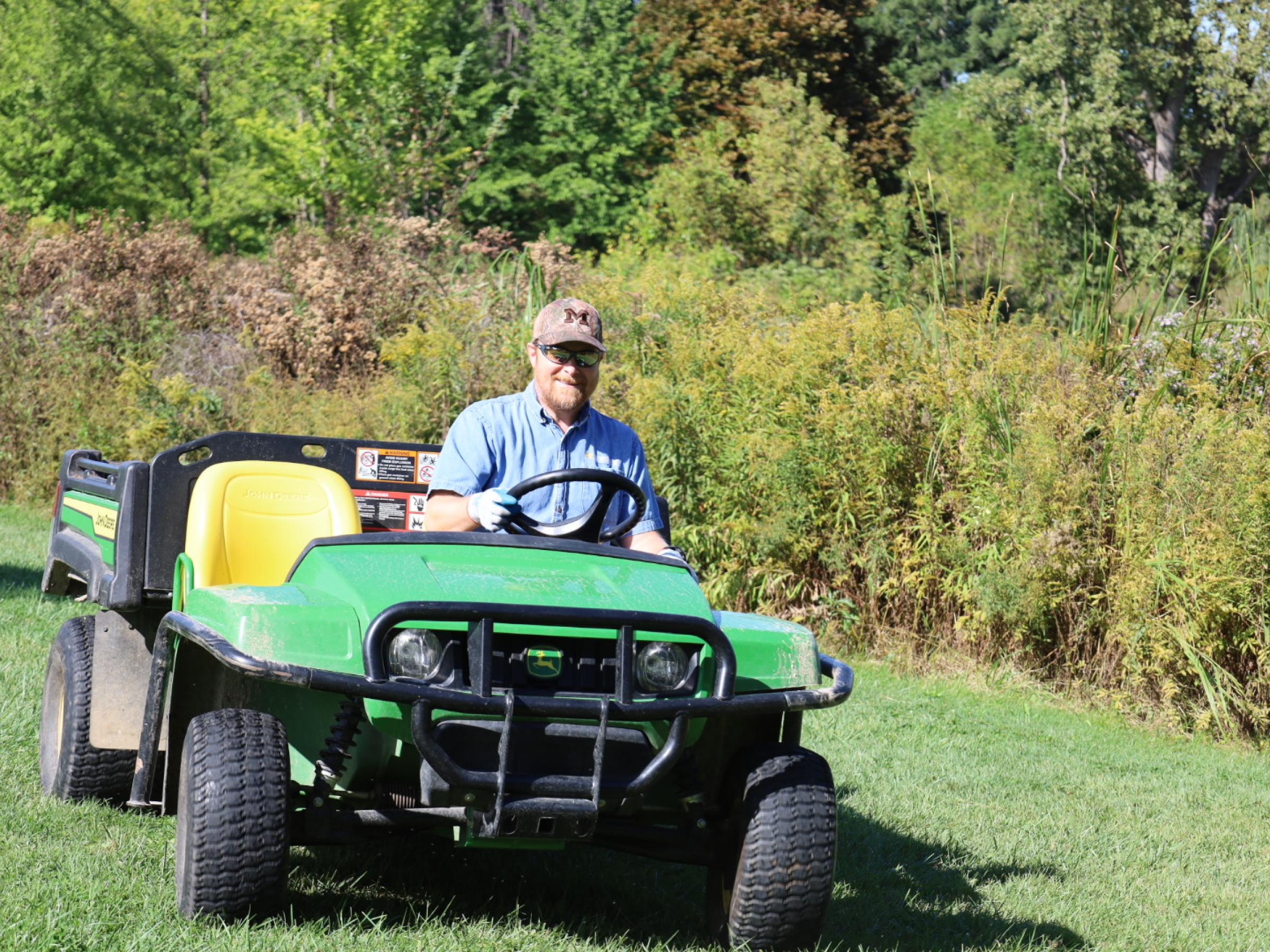 jeff in electric cart near willow pond