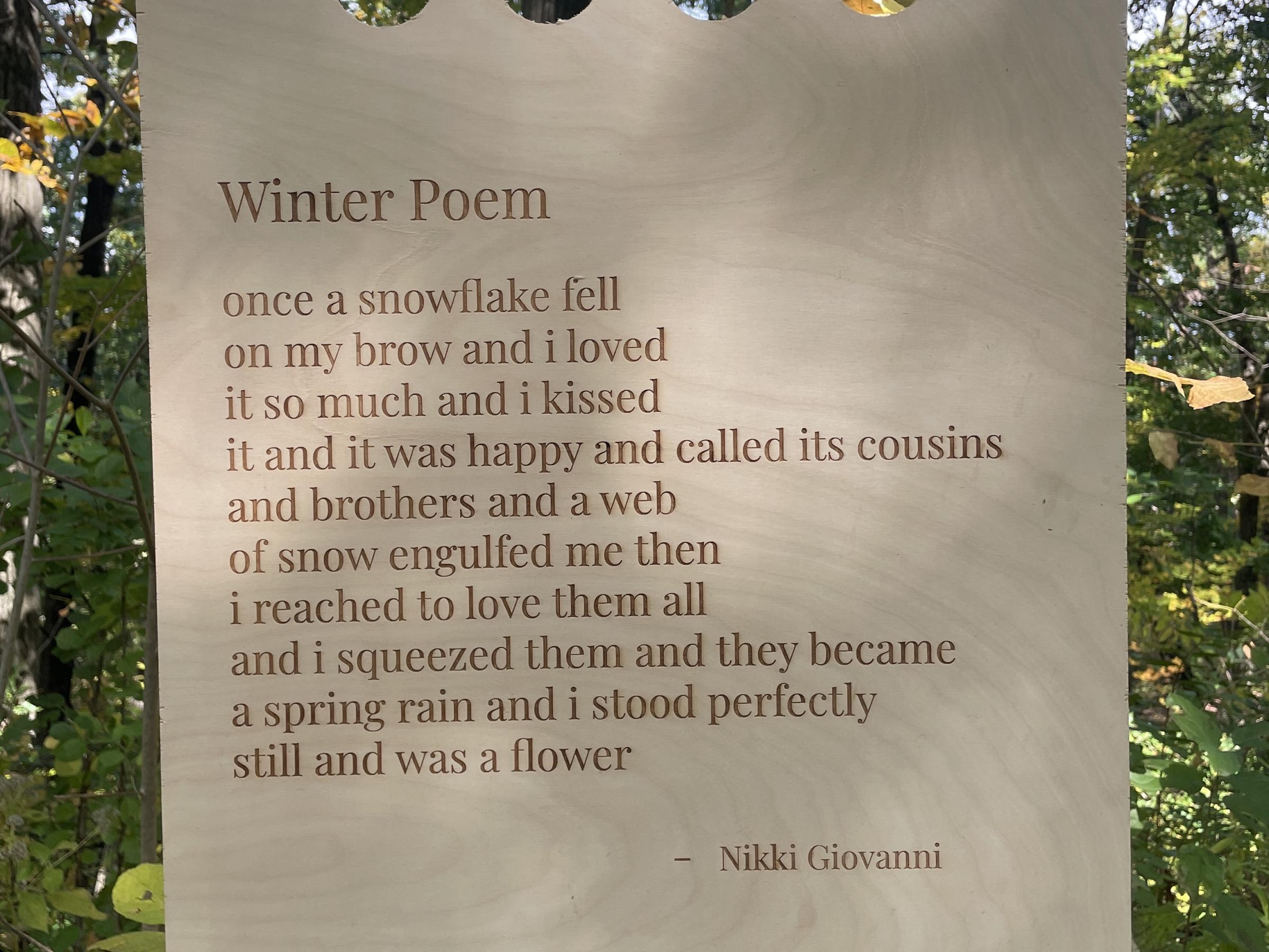 Wooden sign with Winter Poem by Nikki Giovanni on it