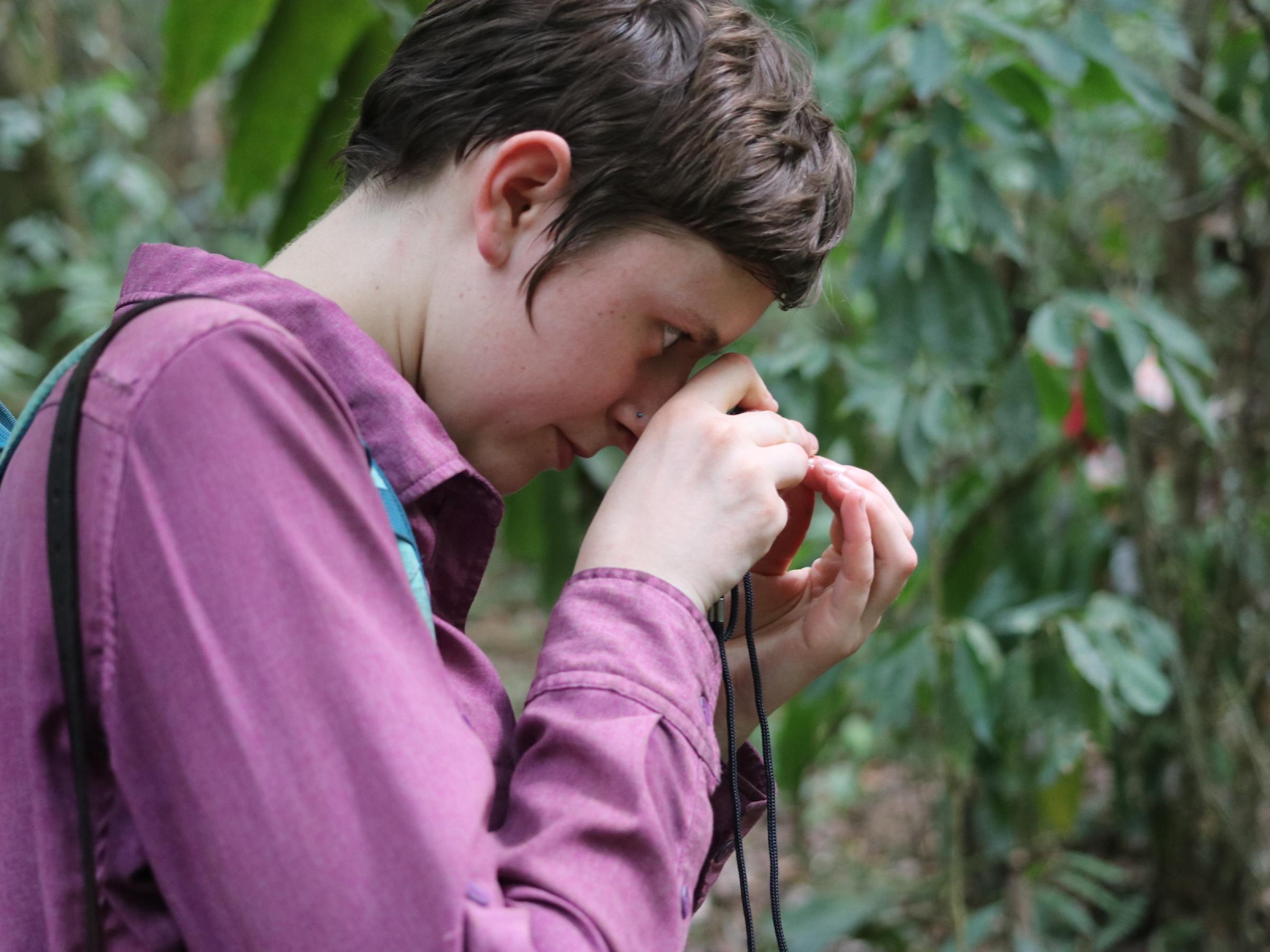 Curator Rosemary Glos uses a hand lens to examine a plant up close. Photo by: Dave Katz