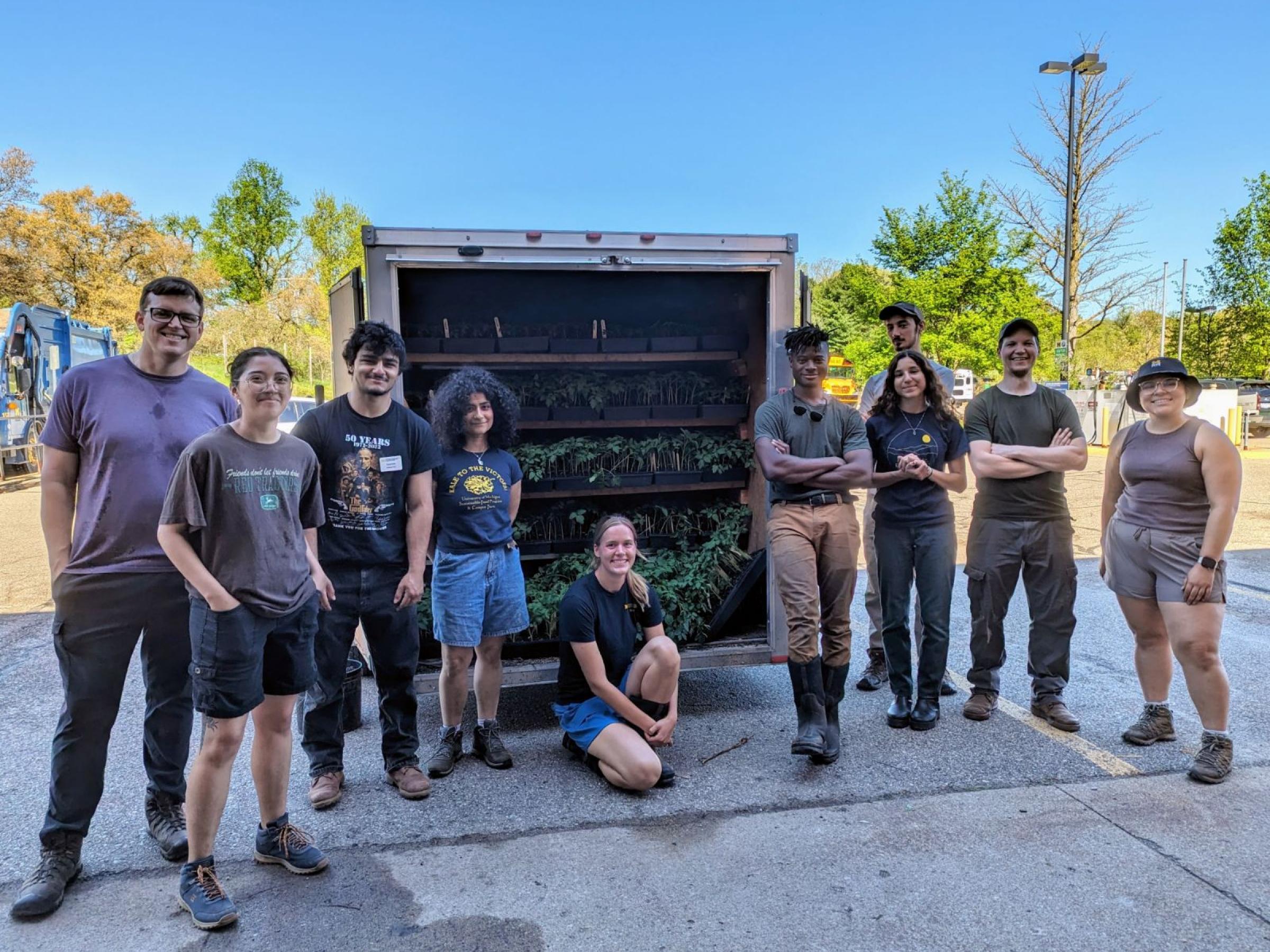 Group of Campus Farm workers, including Yumna Dagher, with a truck loaded with tomatoes for Growing Hope