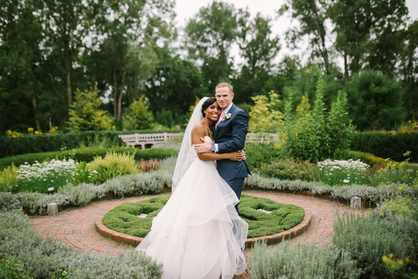 A wedding photo of a couple in the herb knot garden