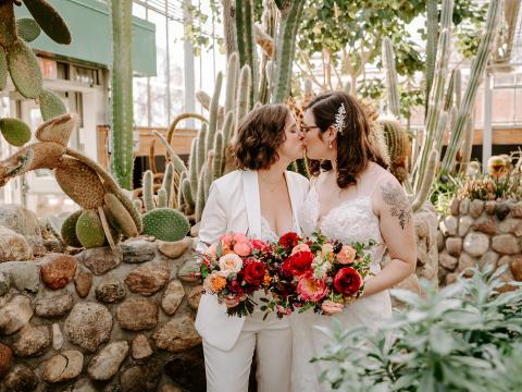 A couple kissing each other in the conservatory after marriage