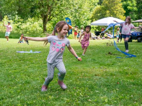 children smile and run with kites