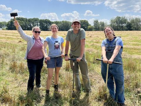 four people in a field 