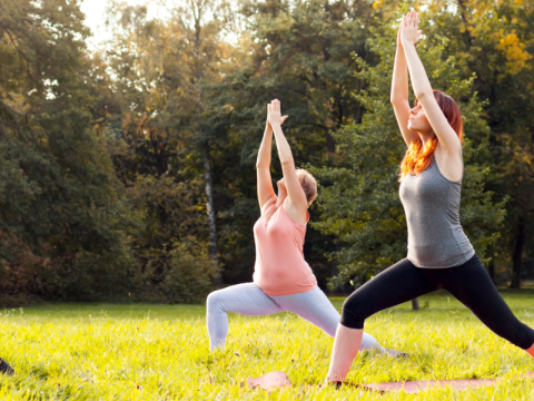 five people outdoors standing dong yoga move