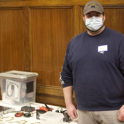 UM student Michael Ficaj stands next to a Direct Air Capture device