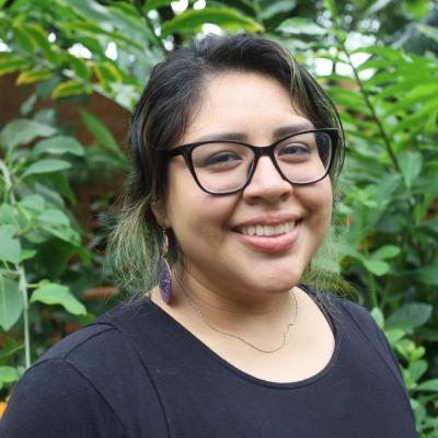 Ariana Bautista smiles in tropical house at Matthaei Botanical Gardens