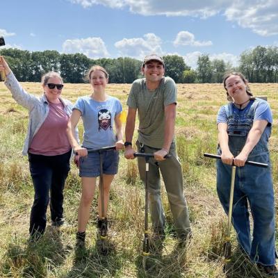 four people in a field 