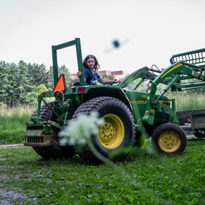 Intern operating a tractor