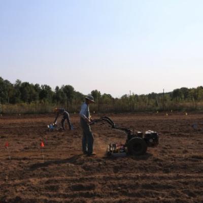 two people working in a farm field