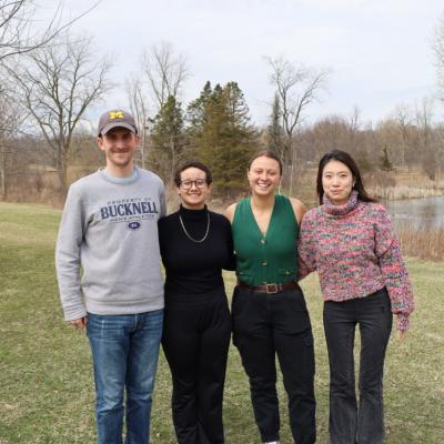 group of four students standing outside
