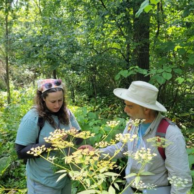 Mike Kost and student look at plants outside