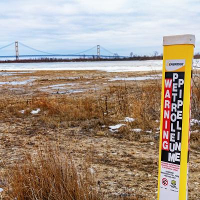 An Enbridge Energy "Warning: Petroleum Pipeline" at the site of the Line 5 oil pipeline site at the Straits of Mackinac between Lake Michigan and Lake Huron.